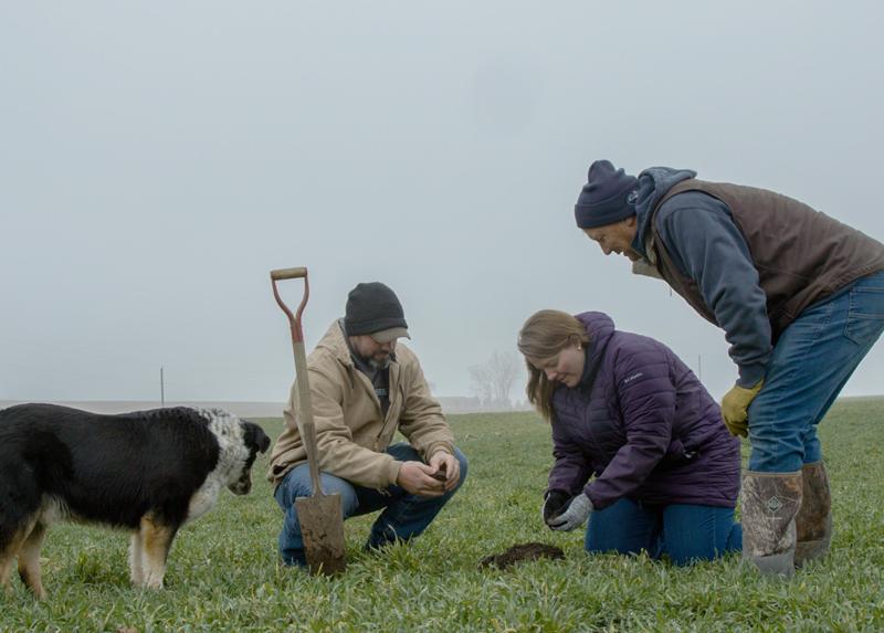 farmers inspect soil dog positive agriculture - stories_video-player-image-1200x860