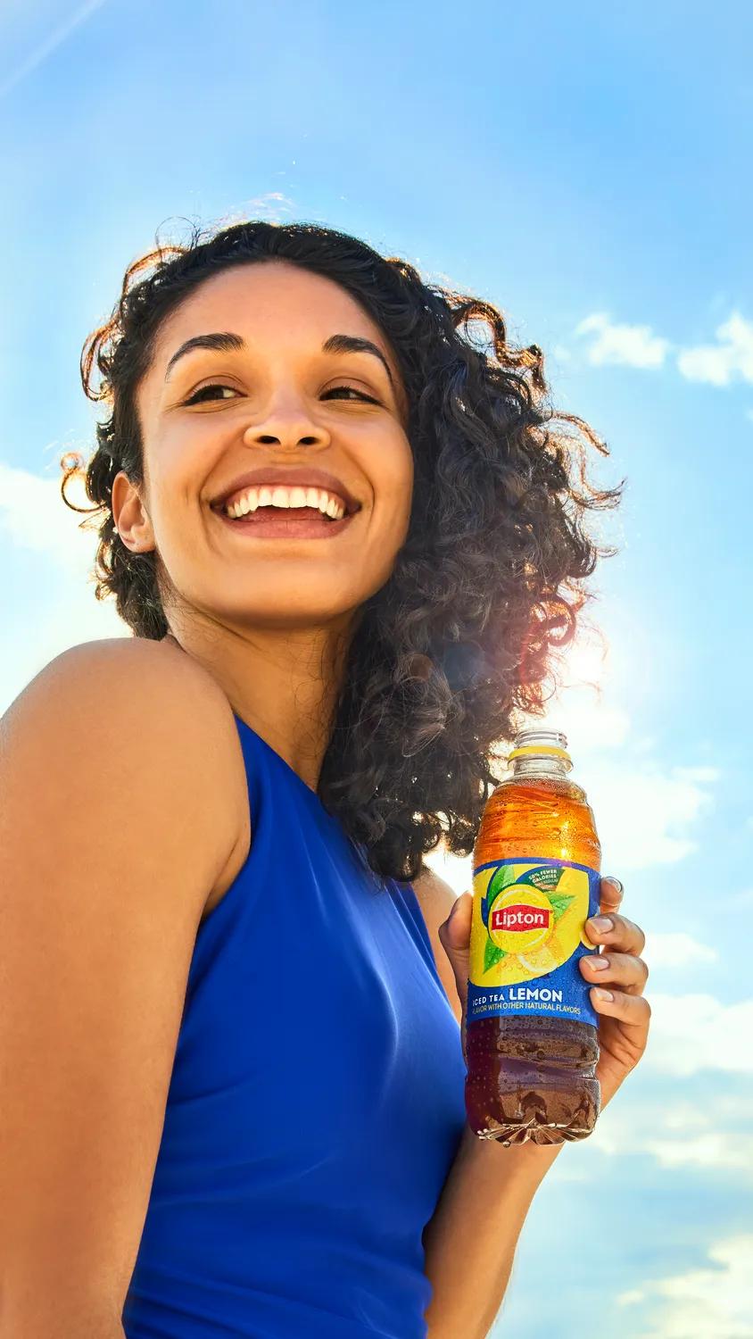 lipton-more-from-rtd-lemon-woman-holding-bottle