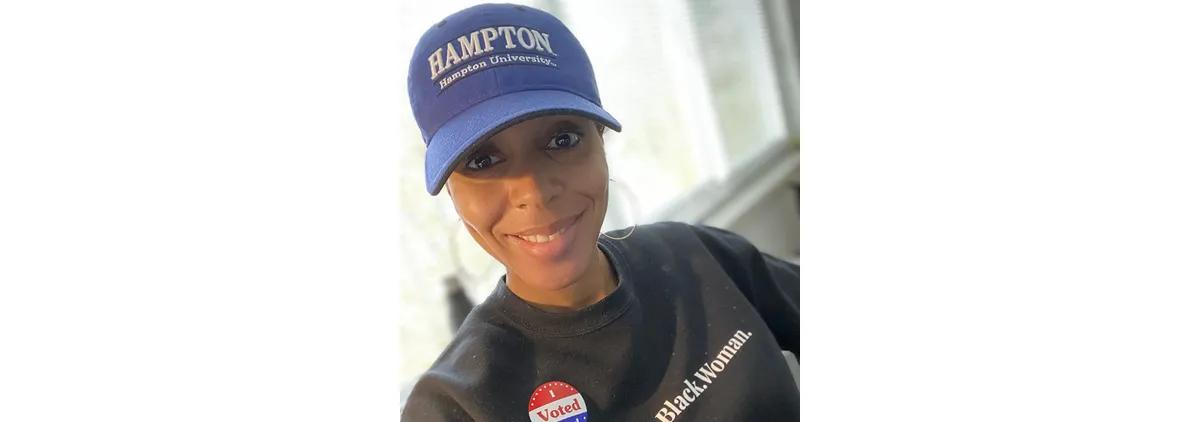 Nicole wears a hat from her alma mater on Election Day.