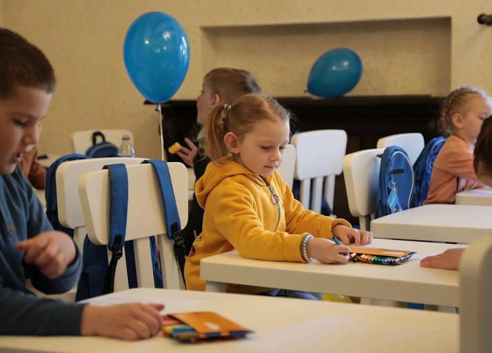 A young student colors alongside classmates at PepsiCo’s learning center for Ukrainian children, which opened in Bucharest, Romania in April.