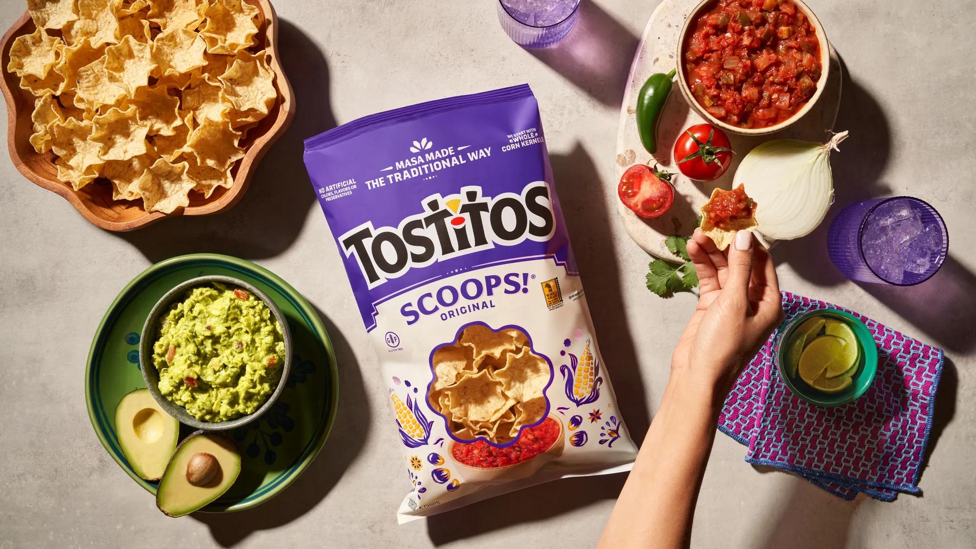 Tostitos® SCOOPS!® Original in refreshed packaging, surrounded by fresh ingredients and dips. Photo credit: D3 studio.