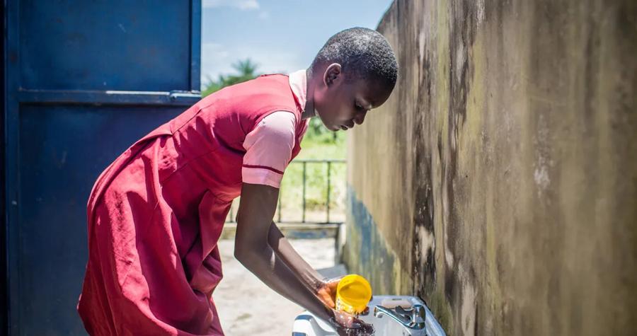 Maria uses a sink that provides clean water in Nigeria, where the PepsiCo Foundation and WaterAid have launched a project that includes building new sanitation facilities in public areas. (Tom Saater/WaterAid)
